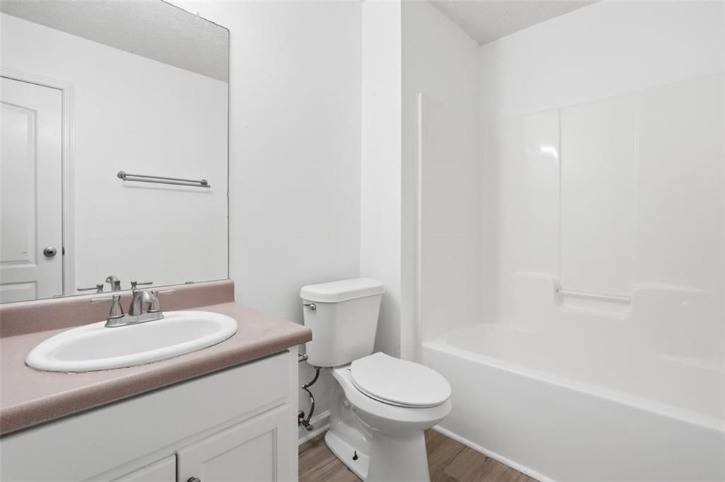 640 Howell Drive Locust Grove, GA 30248 - Photo 13 of 41 a bathroom with a sink toilet and a mirror