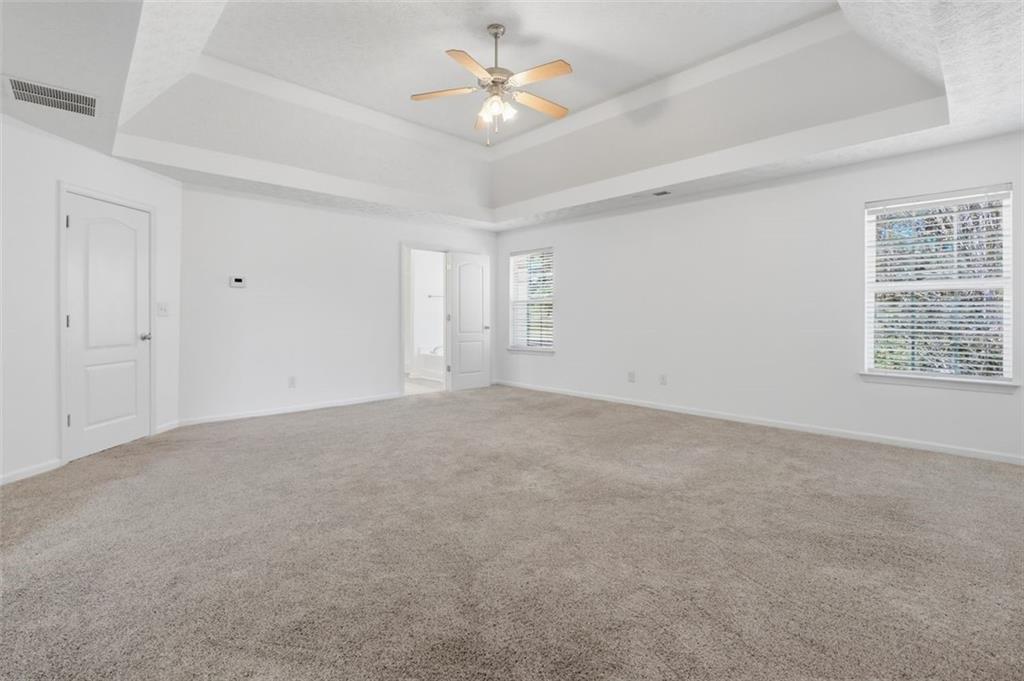 640 Howell Drive Locust Grove, GA 30248 - Photo 22 of 41 a view of an empty room with a ceiling fan and window