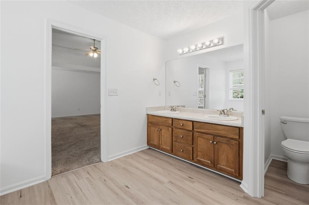 640 Howell Drive Locust Grove, GA 30248 - Photo 26 of 41 a spacious bathroom with a double vanity sink a toilet and a mirror