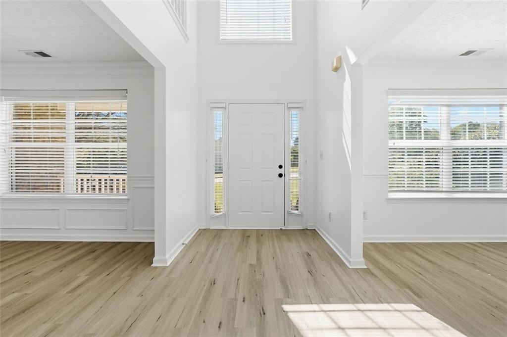 640 Howell Drive Locust Grove, GA 30248 - Photo 3 of 41 an empty room with wooden floor and windows