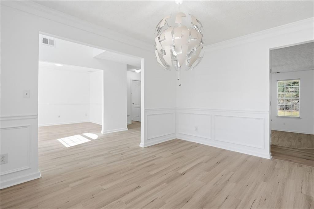 640 Howell Drive Locust Grove, GA 30248 - Photo 4 of 41 an empty room with wooden floor