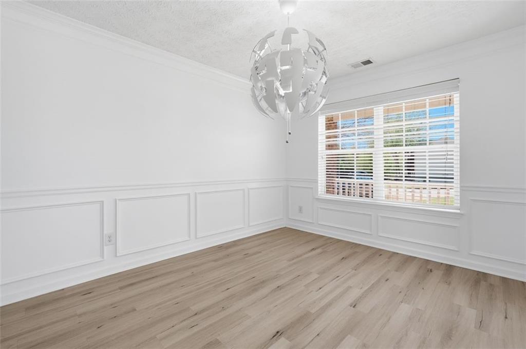 640 Howell Drive Locust Grove, GA 30248 - Photo 5 of 41 wooden floor in an empty room with a window