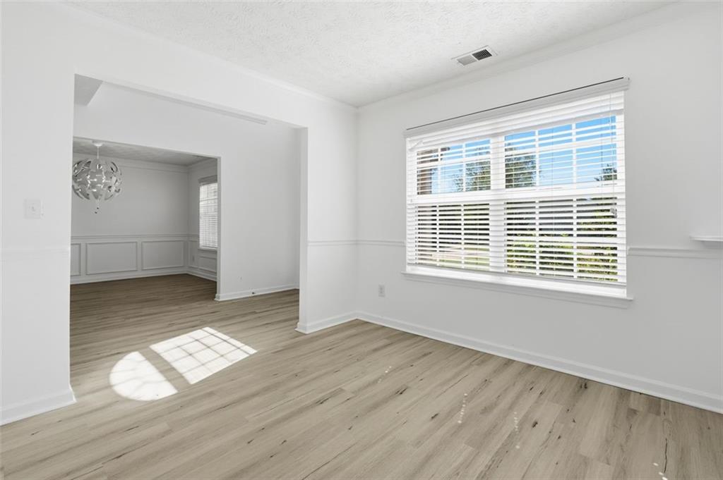 640 Howell Drive Locust Grove, GA 30248 - Photo 7 of 41 a view of empty room with wooden floor and fan