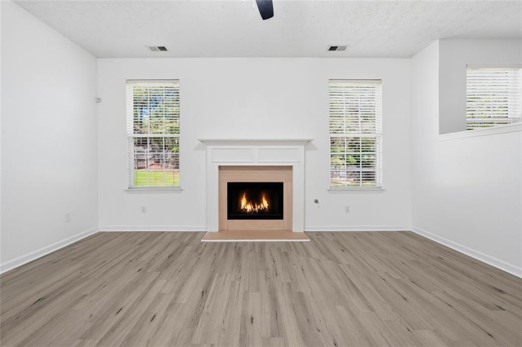 640 Howell Drive Locust Grove, GA 30248 - Photo 9 of 41 an empty room with windows and fireplace