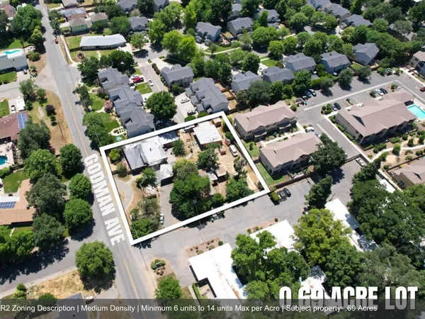 an aerial view of multiple houses with yard