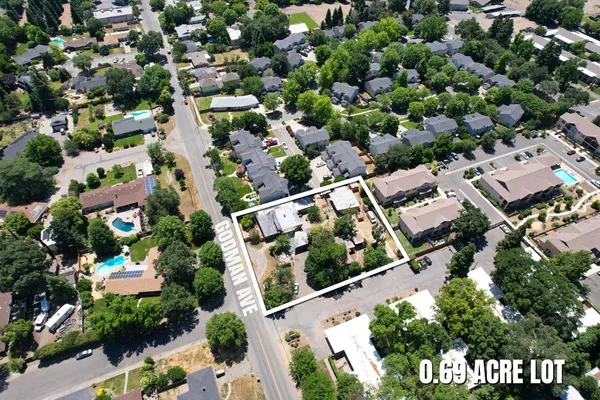 an aerial view of multiple houses with yard