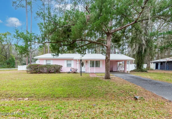 a house that has a big yard with large trees