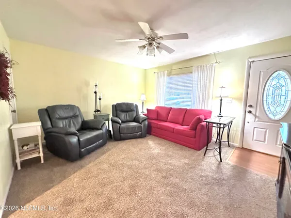 a living room with furniture and a large window