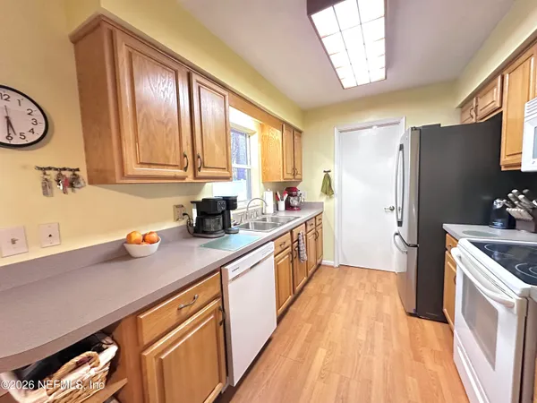 a kitchen with stainless steel appliances a sink a stove and a window