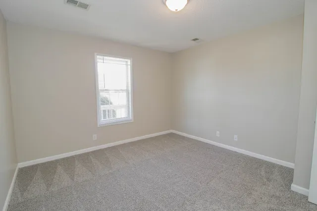 an empty room with closet and wooden door