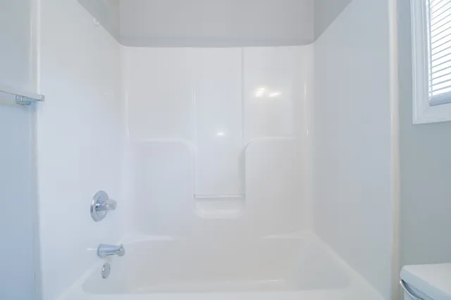 an empty room with a empty space and windows