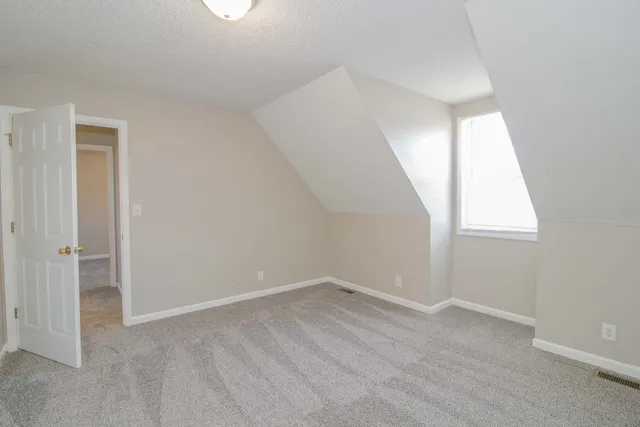 a view of an empty room and closet area