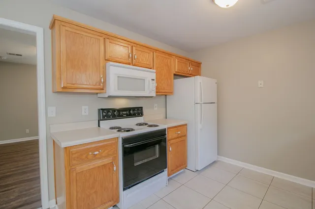a kitchen with a stove top oven sink and a refrigerator