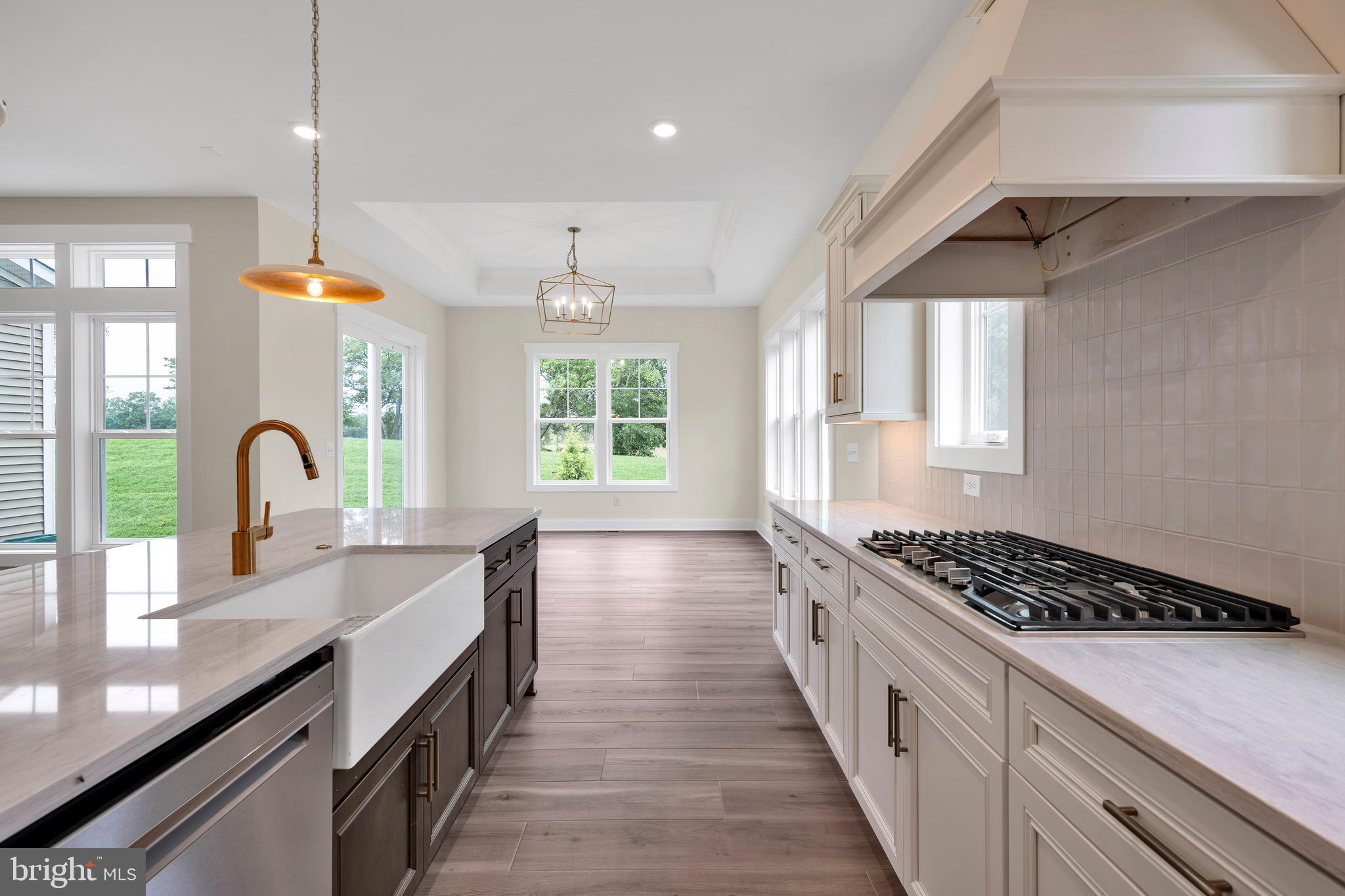 23412 East Gate Drive Frankford, DE 19945 - Photo 11 of 28 a kitchen with kitchen island a counter space a sink a window and stainless steel appliances