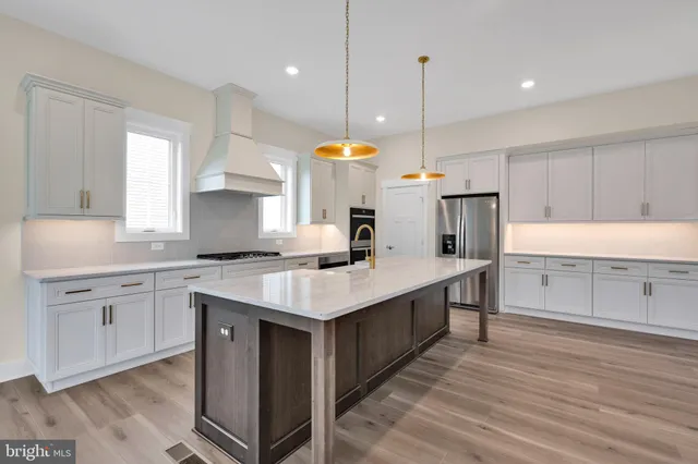 a kitchen with a sink cabinets and window