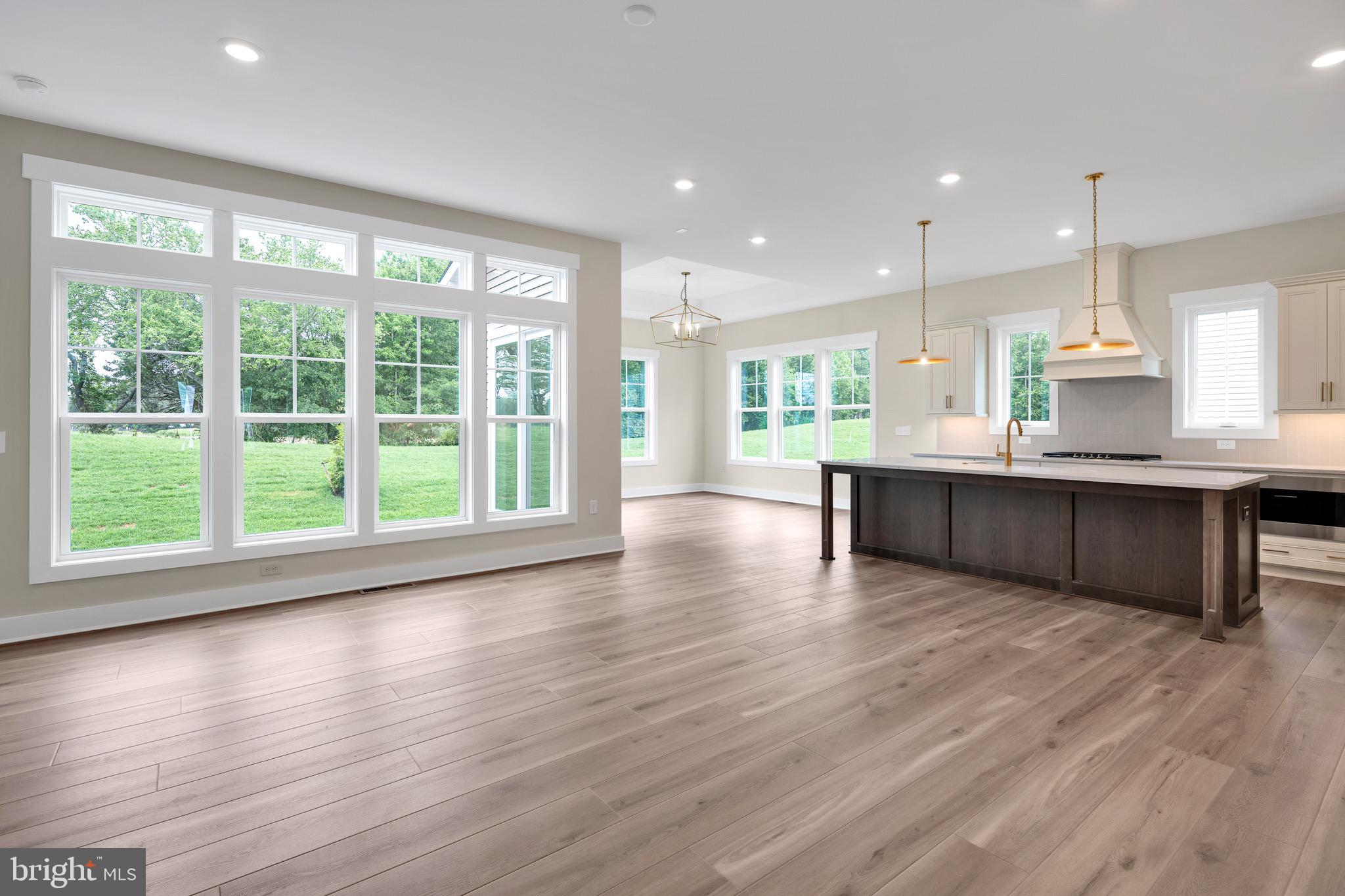 23412 East Gate Drive Frankford, DE 19945 - Photo 17 of 28 a large kitchen with large windows and wooden floor