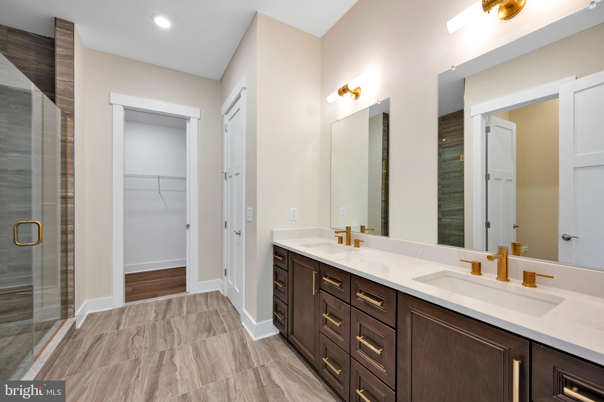 23412 East Gate Drive Frankford, DE 19945 - Photo 21 of 28 a bathroom with a double vanity sink and a mirror