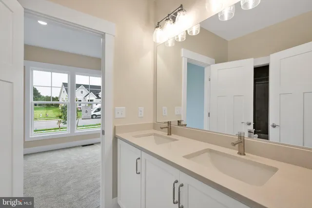 a bathroom with a sink a vanity and a mirror