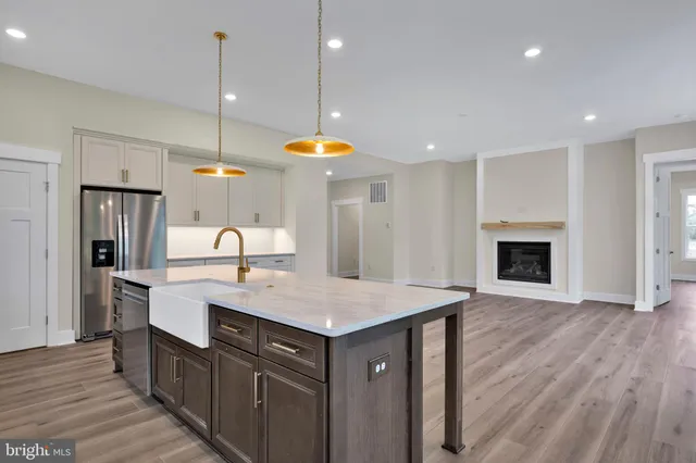 a kitchen with a sink cabinets and wooden floor