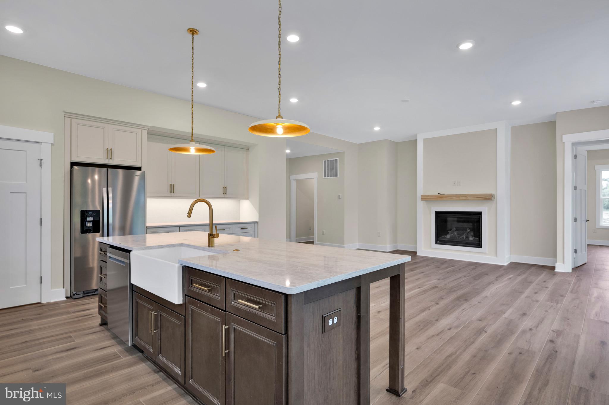 23412 East Gate Drive Frankford, DE 19945 - Photo 9 of 28 a kitchen with a sink cabinets and wooden floor