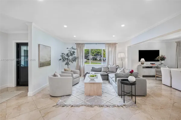 a living room with furniture and a large window