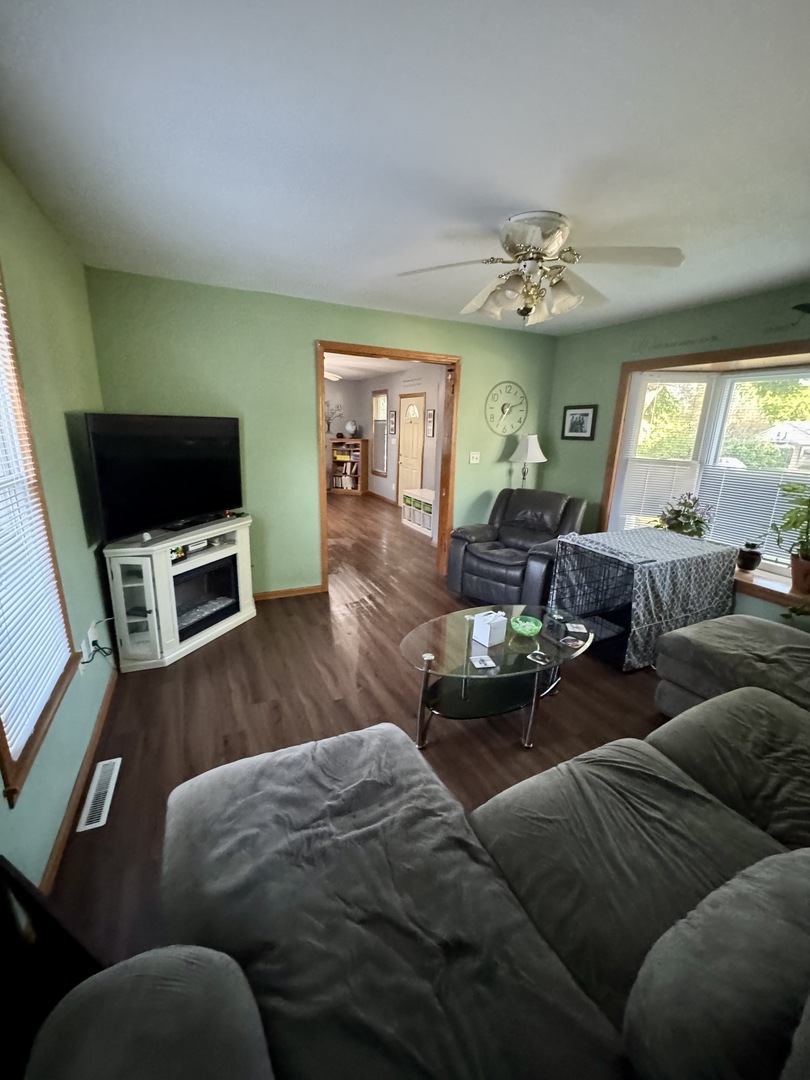 301 West Jackson Street Ohio, IL 61349 - Photo 23 of 32 a living room with furniture a fireplace and a flat screen tv