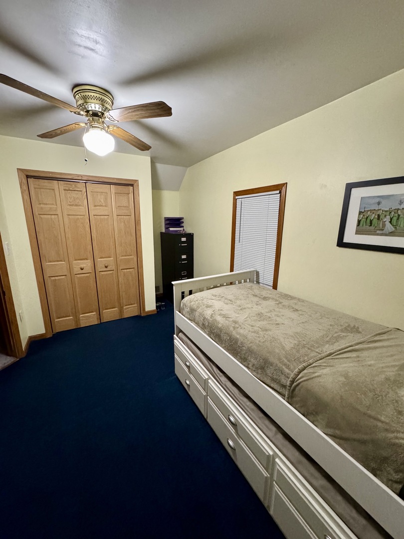 301 West Jackson Street Ohio, IL 61349 - Photo 25 of 32 a bedroom with a bed and a chandelier