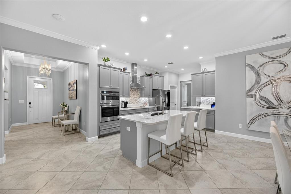 16805 Banner Shell Place Wimauma, FL 33598 - Photo 11 of 44 a large kitchen with a table and chairs