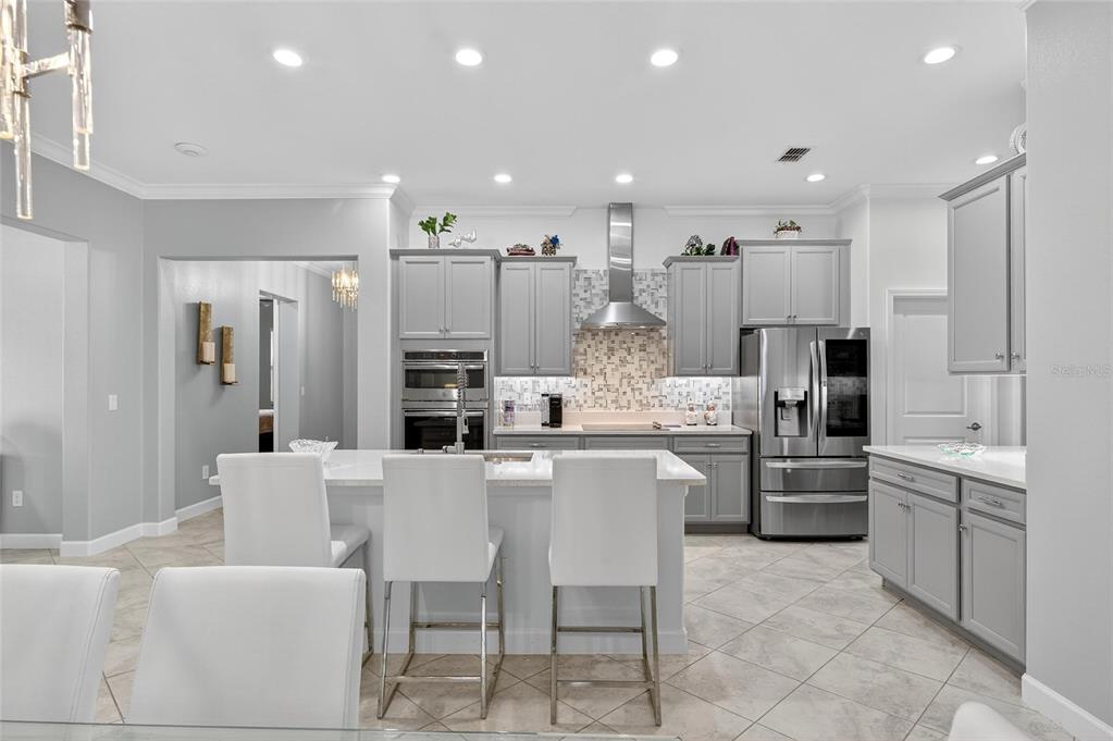 16805 Banner Shell Place Wimauma, FL 33598 - Photo 14 of 44 a large kitchen with a table and chairs