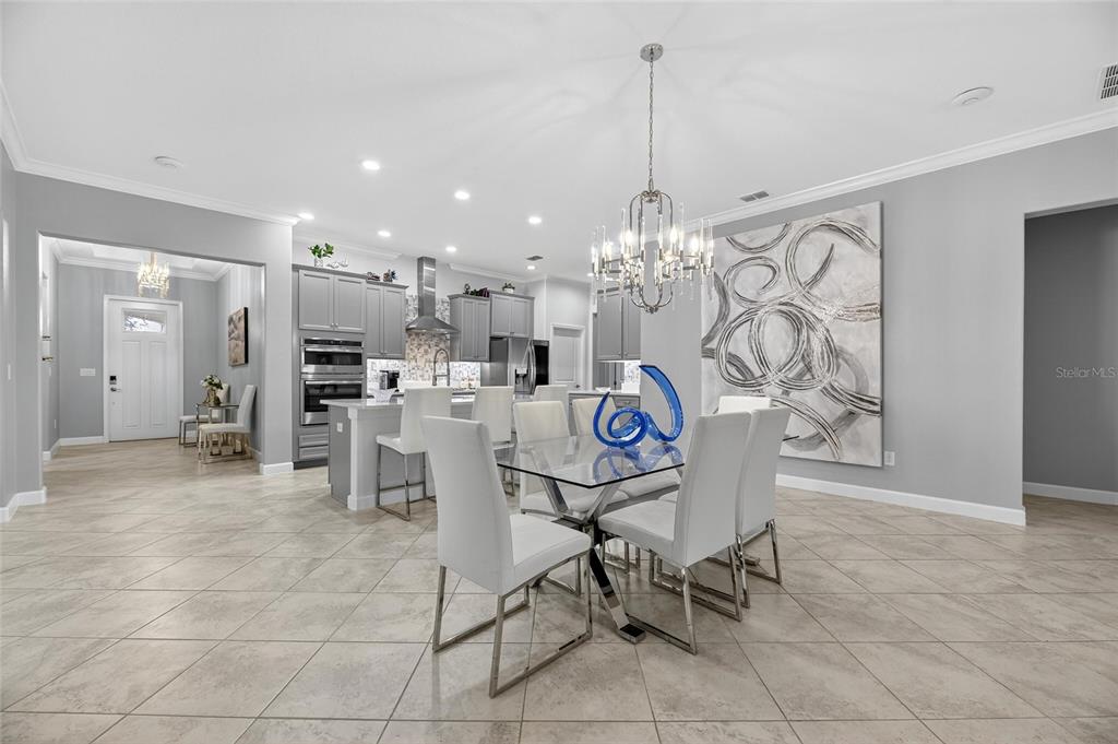 16805 Banner Shell Place Wimauma, FL 33598 - Photo 17 of 44 a view of a kitchen and dining area windows