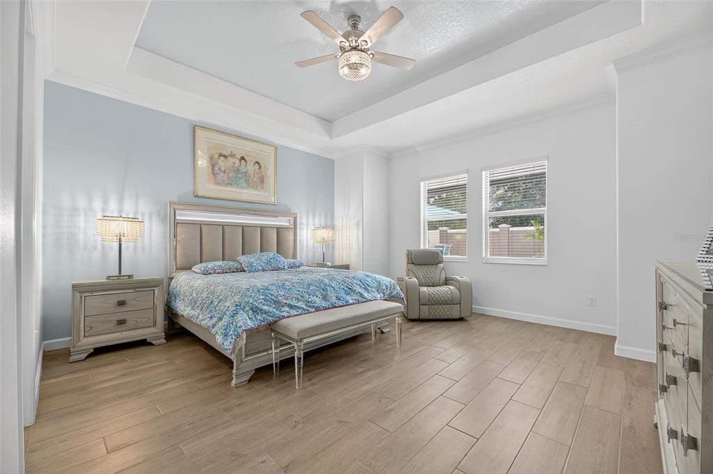 16805 Banner Shell Place Wimauma, FL 33598 - Photo 19 of 44 a bedroom with a bed and wooden floor