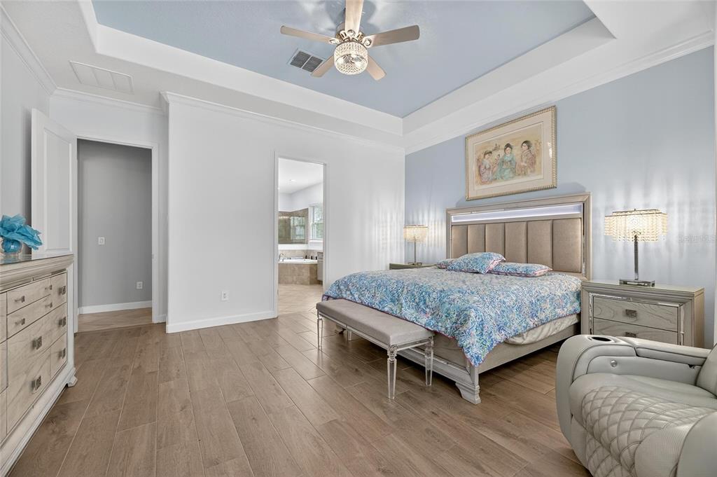 16805 Banner Shell Place Wimauma, FL 33598 - Photo 20 of 44 a bedroom with bed and wooden floor