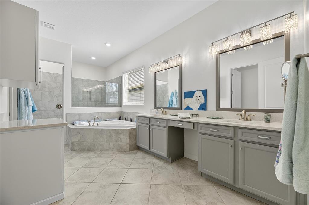 16805 Banner Shell Place Wimauma, FL 33598 - Photo 21 of 44 a large bathroom with a double vanity sink mirror and bathtub