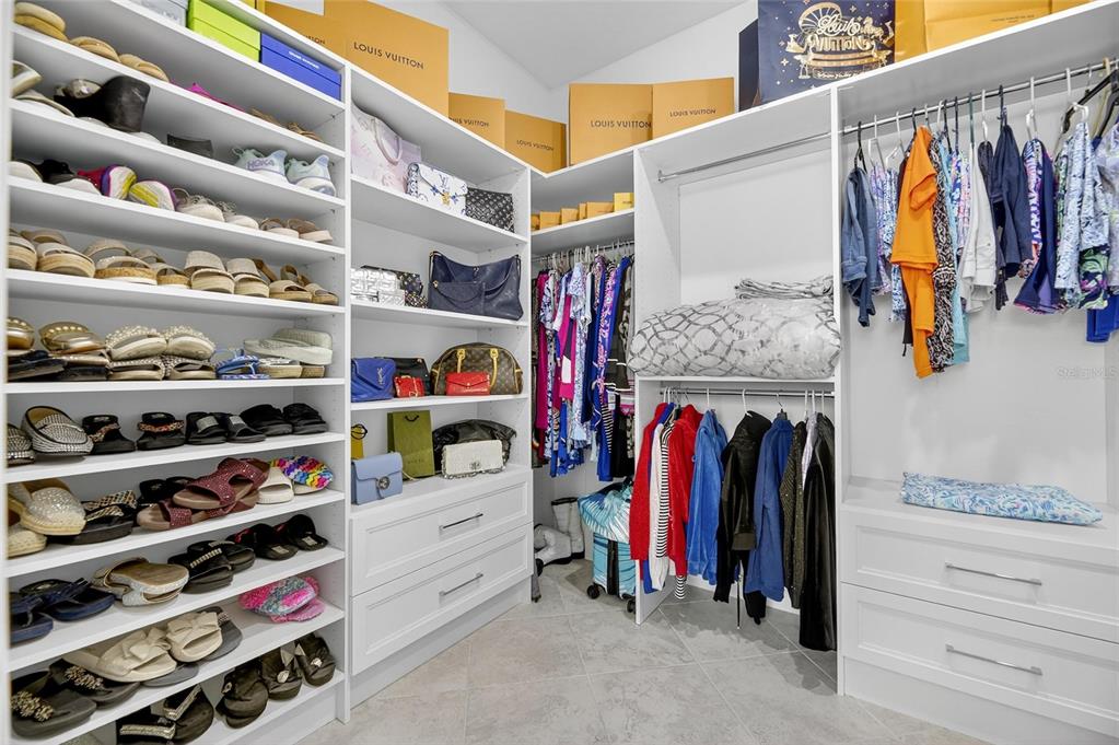 16805 Banner Shell Place Wimauma, FL 33598 - Photo 24 of 44 a view of walk in closet with clothes and shoes
