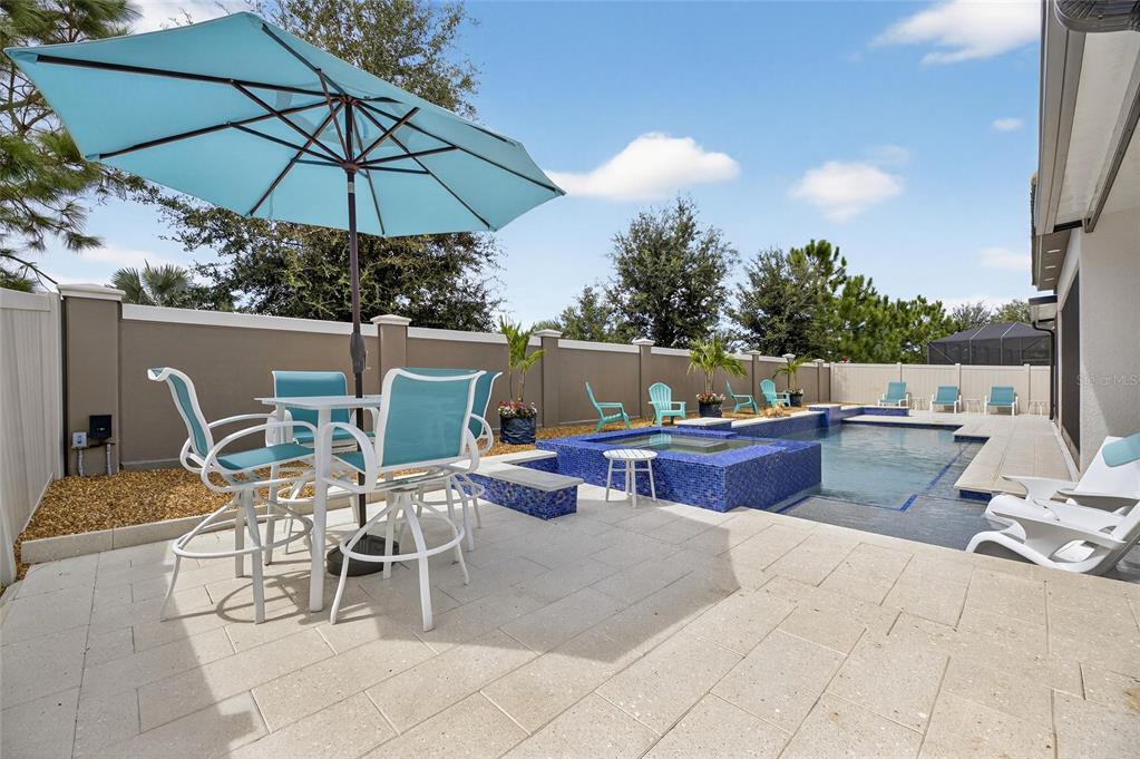 16805 Banner Shell Place Wimauma, FL 33598 - Photo 5 of 44 a view of a patio with a table and chairs under an umbrella
