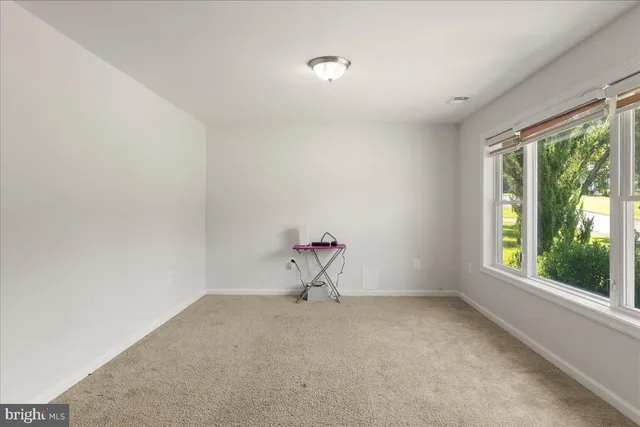 a room with a window and ceiling fan
