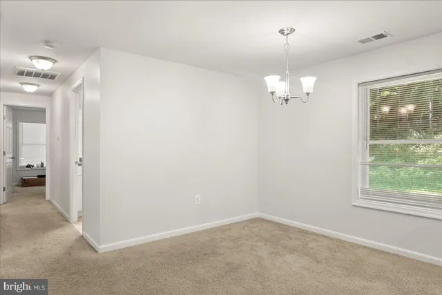 en empty room with windows and entrance