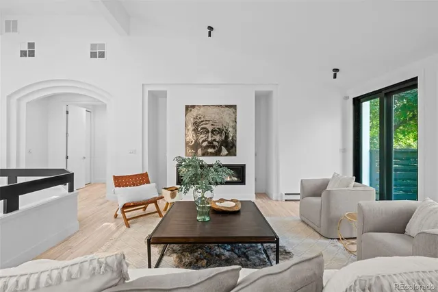 a vase with flowers on a table and a fireplace