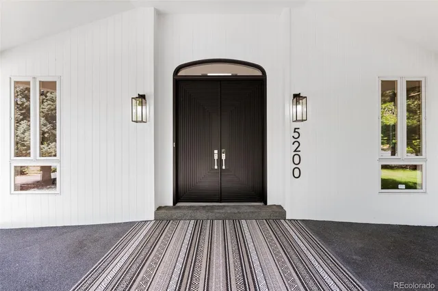 a view of a livingroom with wooden floor and staircase