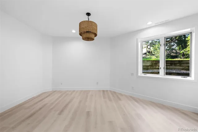 a view of a grassy field with trees in the background