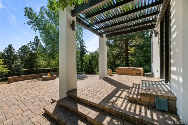 an aerial view of a house with swimming pool next to a big yard