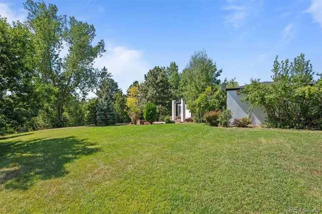 a balcony with wooden floor and fence