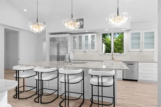 a view of a dining room with furniture a chandelier and wooden floor