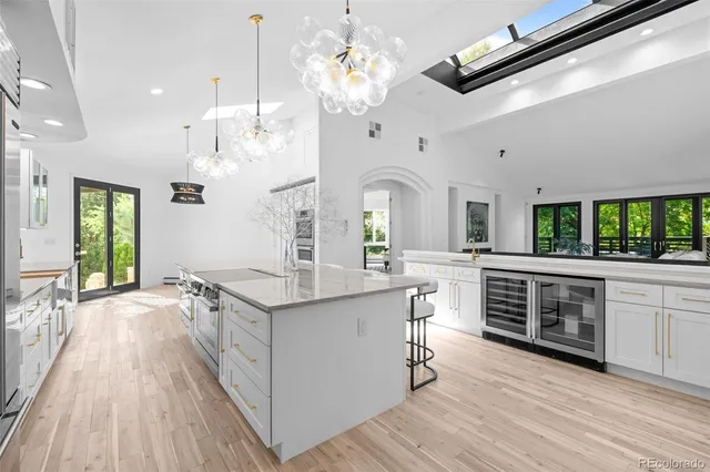 a dining room with chandelier and wooden floor