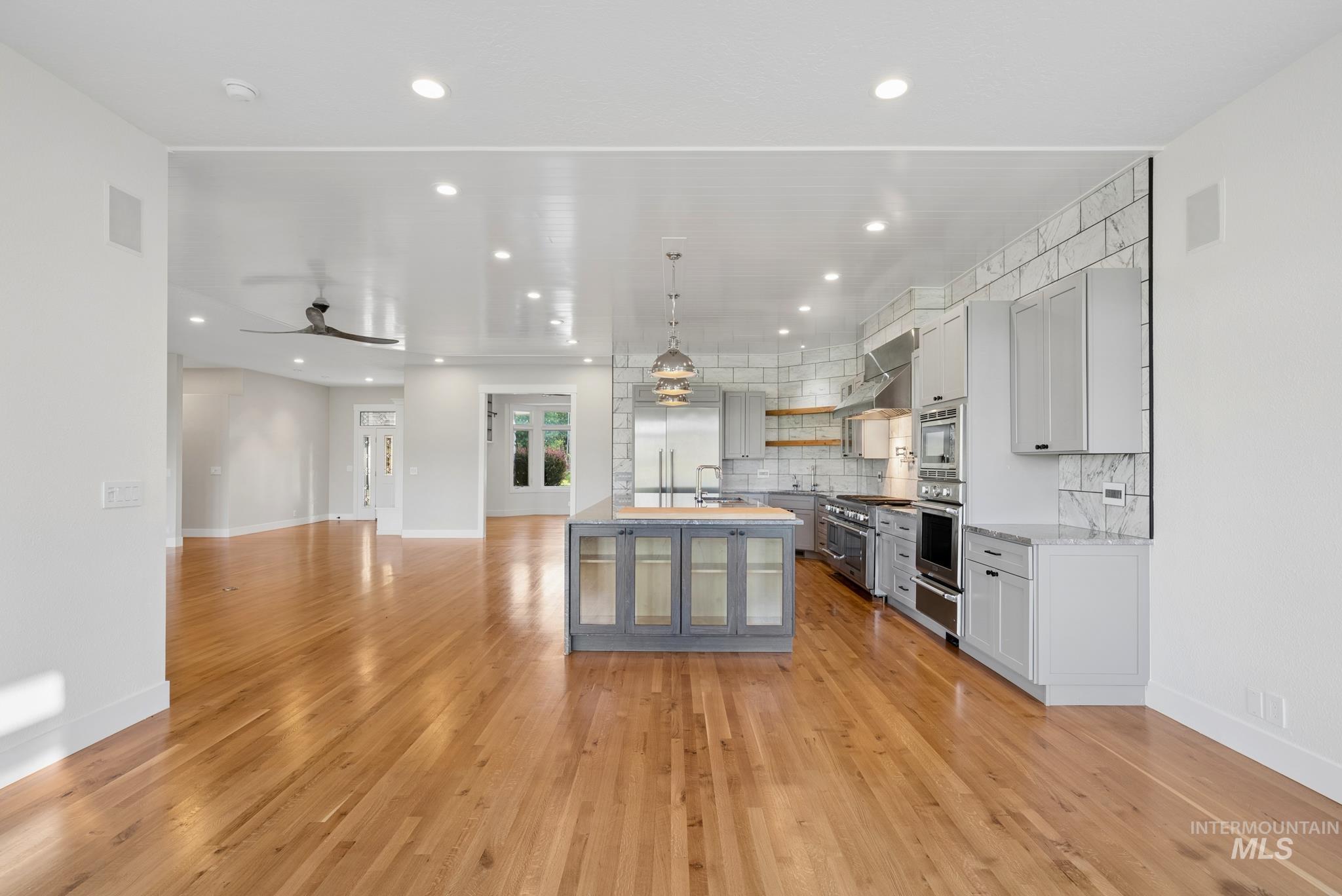 2050 Artesian Road Eagle, ID 83616 - Photo 16 of 49 Spacious interior featuring wood-finish flooring, white walls, recessed lighting, and multiple windows with white trim