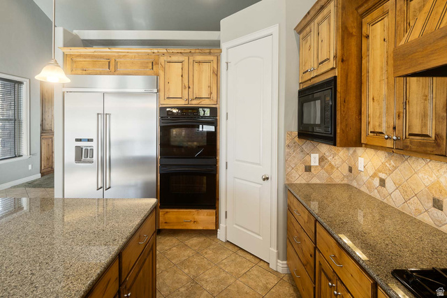 1997 West Cres Drive Mapleton, UT 84664 - Photo 12 of 35 Kitchen with black appliances, dark stone counters, wood finish cabinets, and tasteful backsplash