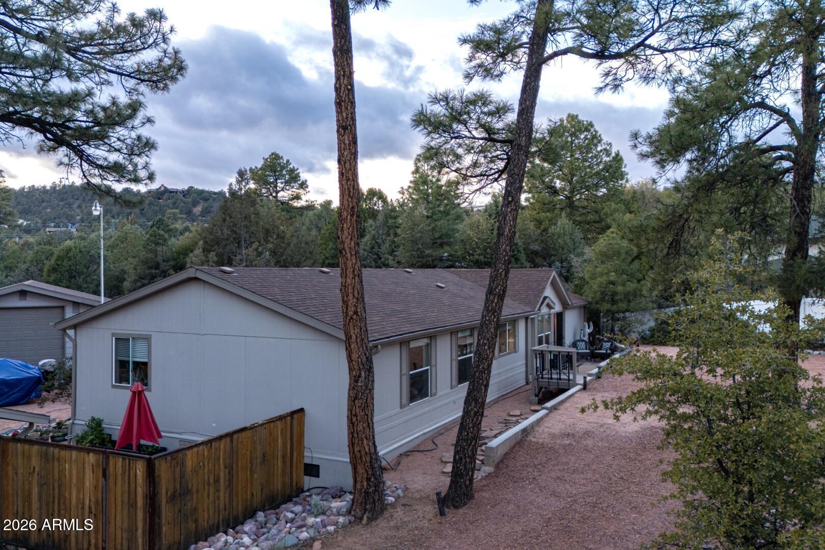 904 North McLane Road Payson, AZ 85541 - Photo 9 of 59 a view of a small house covered with trees in the background