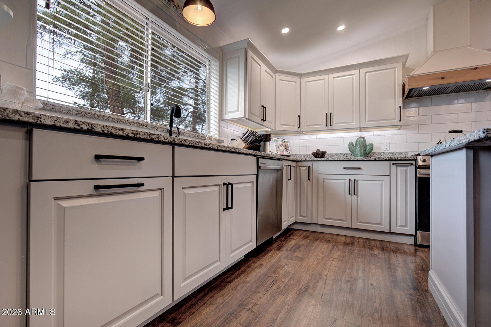 904 North McLane Road Payson, AZ 85541 - Photo 13 of 59 a kitchen with granite countertop white cabinets and white appliances