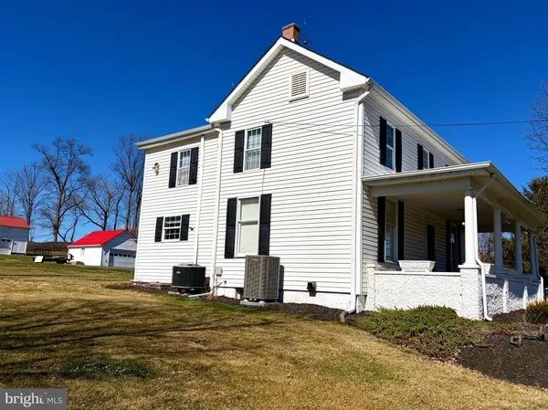 a view of a white house with a yard