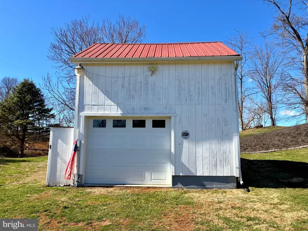 a view of a house with yard and sitting area